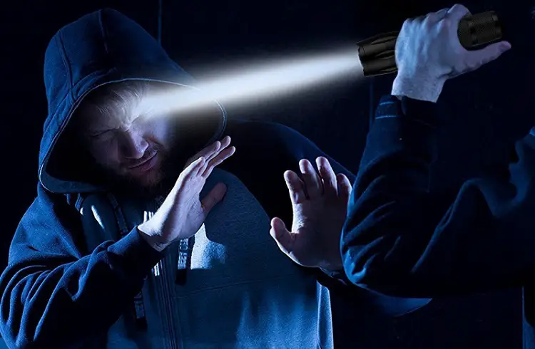blinding attacker with flashlight